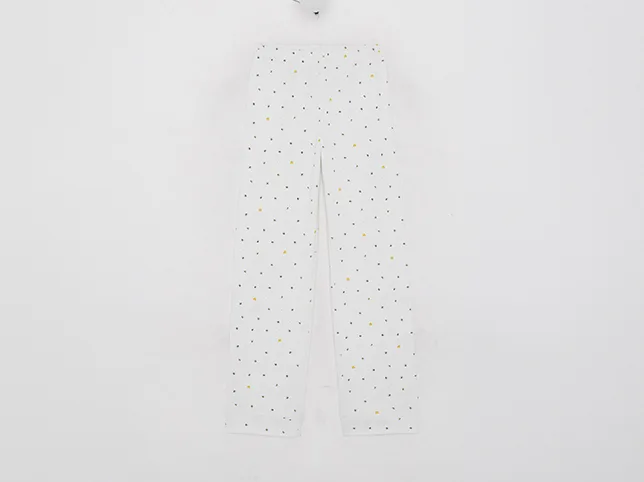 White polka dot trousers before cropping, resizing and listing optimisation
