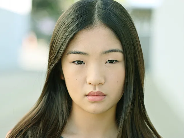 Portrait of a young woman before a green colour cast was removed from the skin