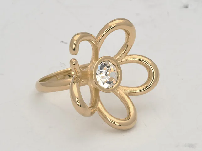 Gold flower ring with a clear stone before the gold was matched to a reference