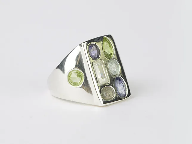 Silver ring set with translucent gemstones before masking that keeps the stones see-through