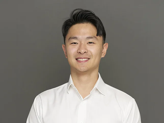 Man in a white shirt before the studio backdrop was replaced