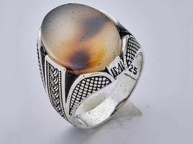 Jewellery before dust and fibre removal showing dust on the metal