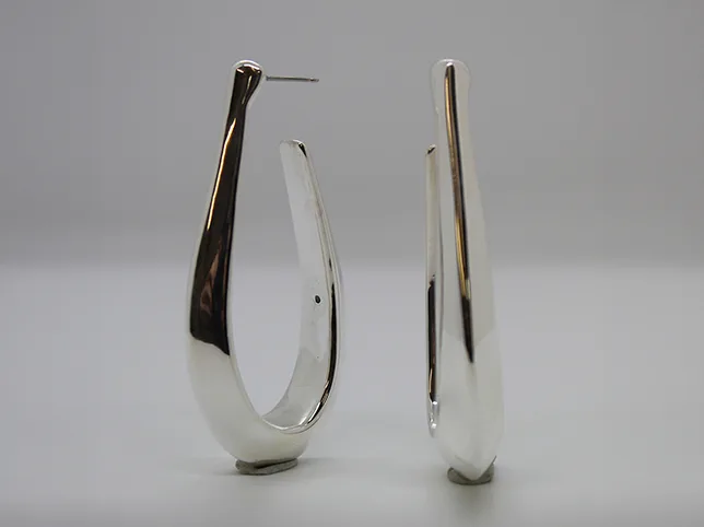 Polished silver drop earrings before reflections and contact shadow were rebuilt