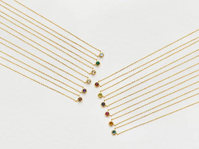 Fine gold chains before hand-drawn clipping paths through the negative space