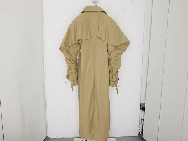 Beige trench dress before creases eased and sample marks removed
