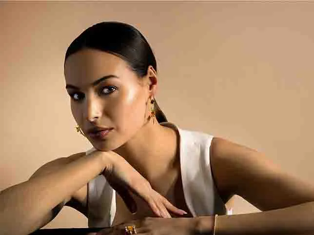 Model in a white top before the backdrop was regraded from beige to green