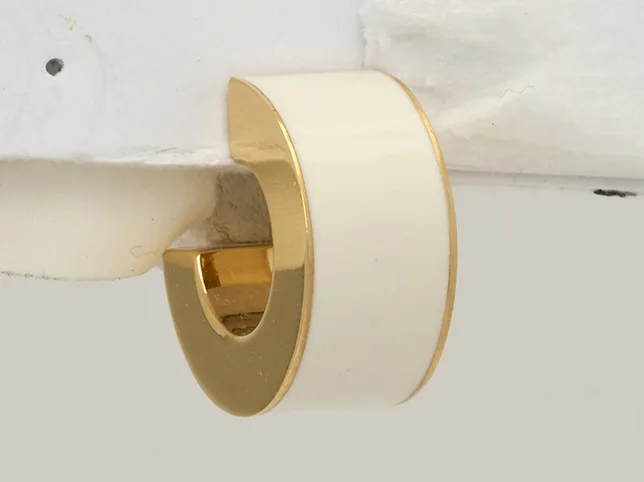 Gold cuff earring before isolation from its rig along a fine edge