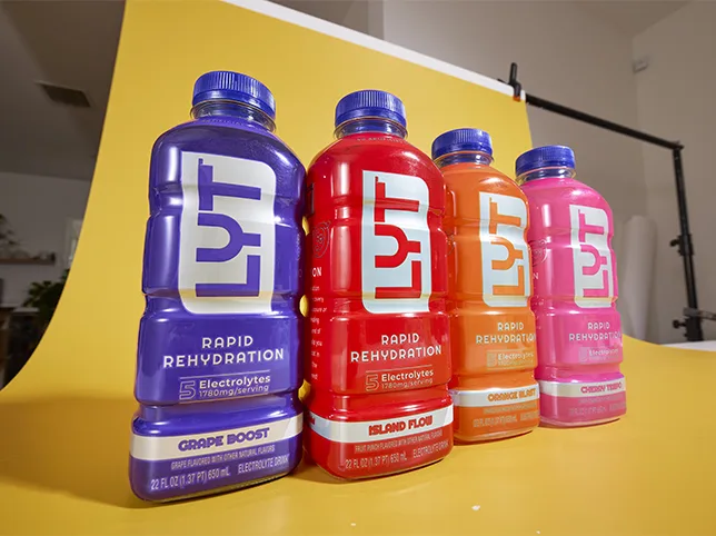 Five drinks bottles before the frame was extended to fill a banner format