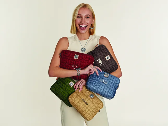 Model holding four handbags before a colour change applied across all four at once