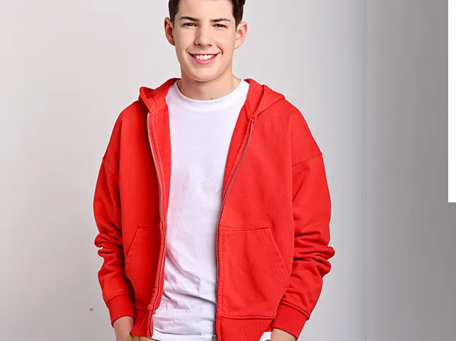 Young man in a red hoodie before portrait enhancement and skin work