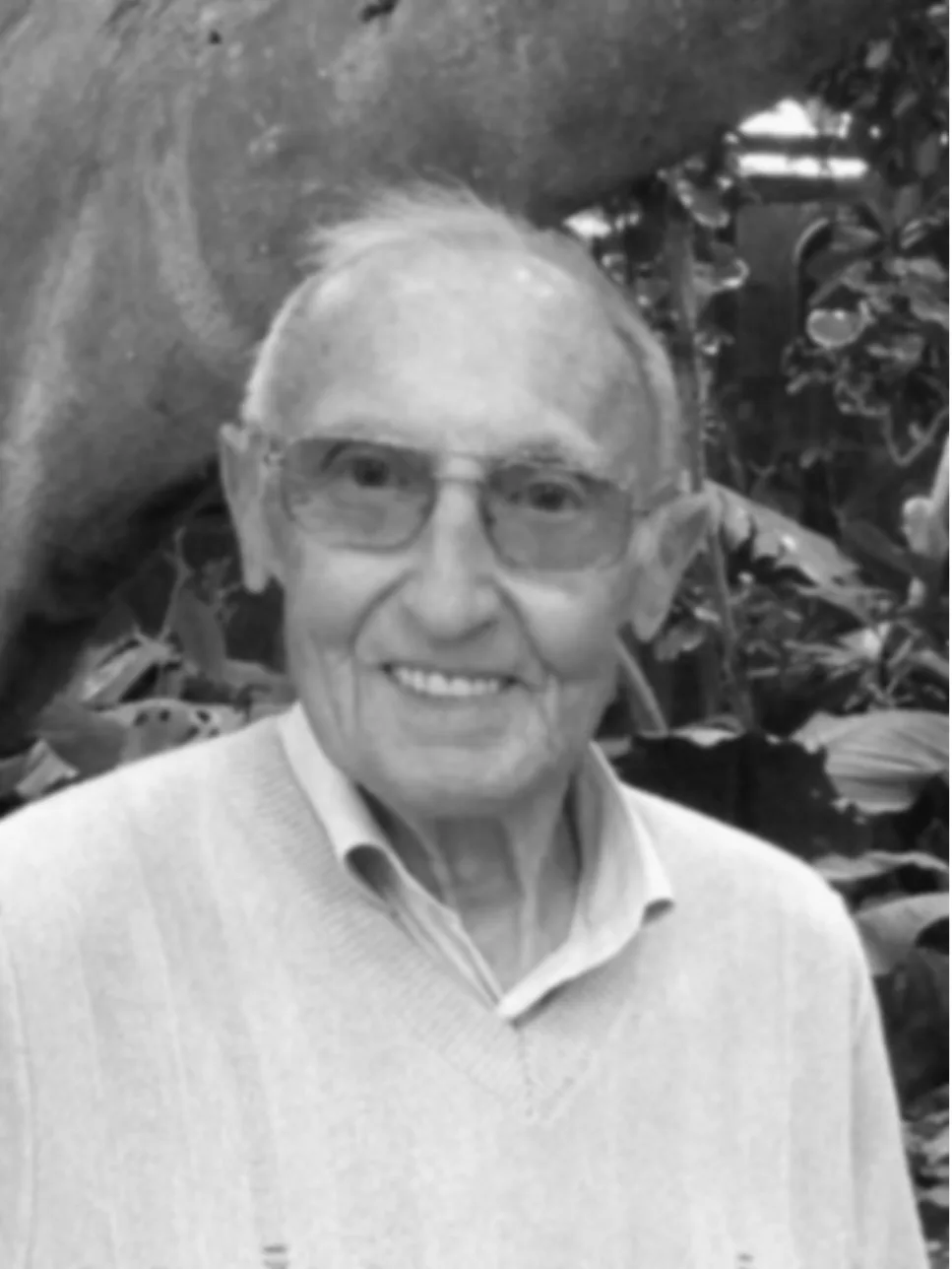 Black and white portrait of an older man before restoration and colourisation