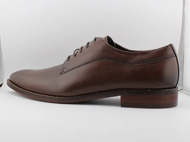 Brown leather derby shoe before colour correction removed the indoor cast