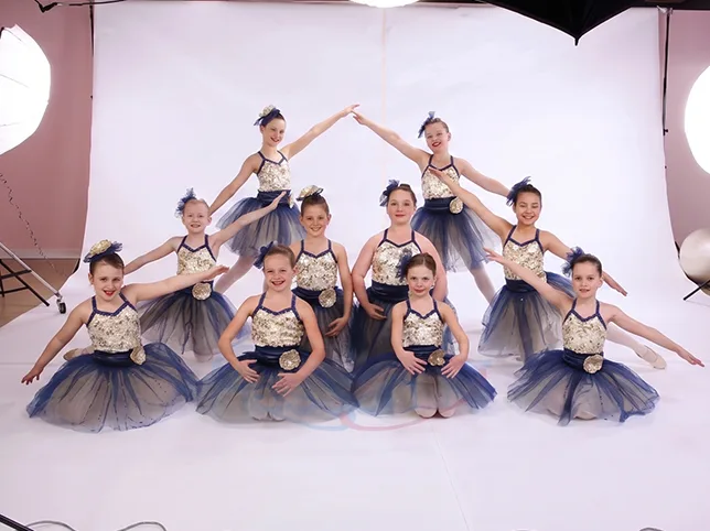 Group of young ballet dancers before the studio backdrop was extended to fill the frame