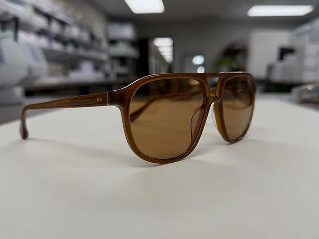 Brown tinted sunglasses before product retouching onto a clean background