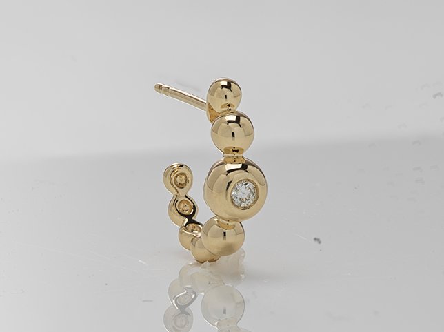 Handmade jewellery before retouching, showing dust and uneven lighting