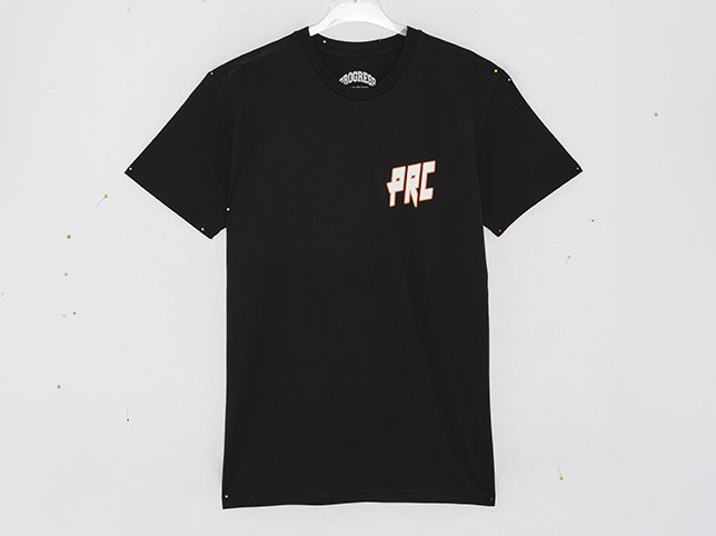 Black graphic t-shirt photographed on a white hanger against a grey speckled background before editing